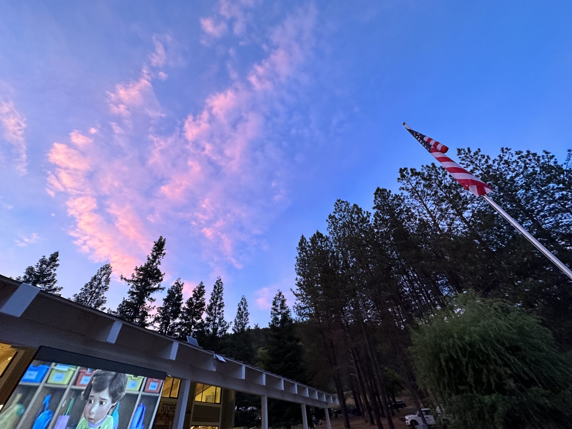 Pink sunset clouds over the campground store and flagpole